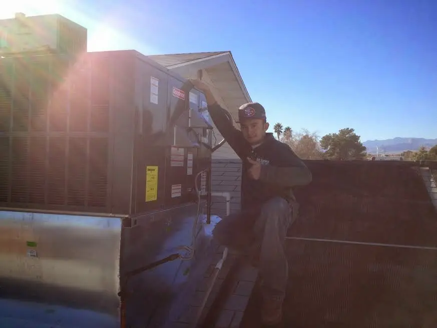 HVAC technician performing AC Tune-Up on a rooftop unit in Bardmoor